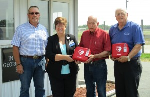 Theresa Rutherford (second from left), HSHS St. Anthony’s Memorial Hospital President and CEO, presents one of two Automated External Defibrillators (AEDs), to members of the Effingham County Fair Board.  With Rutherford are (left to right) Dale Laue, Wilbert Schaefer, and Phil Hartke. HSHS St. Anthony’s donated two AEDs to the fairgrounds and will also be providing Heartsaver AED CPR training for 15-20 staff and volunteers connected with the fairgrounds.