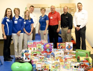 Jake and Roger Buhnerkempe of J&R Collision Centers recently contributed $1,000 of toys, educational materials and physical development items for HSHS St. Anthony’s Memorial Hospital’s Physical Rehabilitation and Wellness department located at the Workman Sports and Wellness Complex.  Shown with the donated items are (left to right) St. Anthony’s pediatric therapists Sarah Buhnerkempe, Occupational Therapist, Keli Dhom, Physical Therapist, and Teresa Beck, Speech Therapist; Jake Buhnerkempe, Co-owner, J&R Collison Centers; Candy Jansen, St. Anthony’s Director of Rehabilitation and Wellness; Michael Wall, St. Anthony’s Director of Philanthropy; Scott Sapp, General Manager, J&R Collison Centers, Effingham; and Daniel Norton, General Manager, J&R Collison Center, Shelbyville.