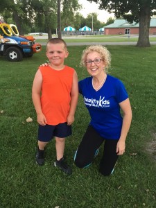 Eight-year-old Kolton Forlines poses with one of his Tom Short Kids Training Team leaders Laura Bollan at Forest Park in Shelbyville.